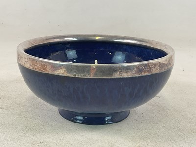 Lot 1145 - ATTRIBUTED TO RUSKIN; a mottled blue glazed...