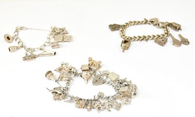 Lot 1053 - Three hallmarked silver charm bracelets set...