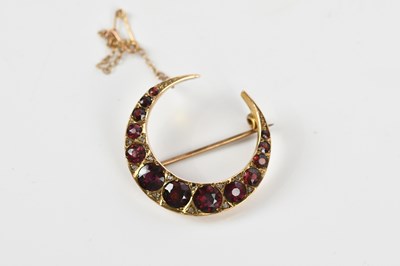 Lot 89 - A Victorian yellow metal crescent brooch set...
