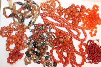 Lot 1191 - A collection of polished hardstone bead...