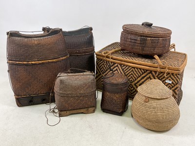 Lot 1172 - A group of Eastern wickerwork baskets with...