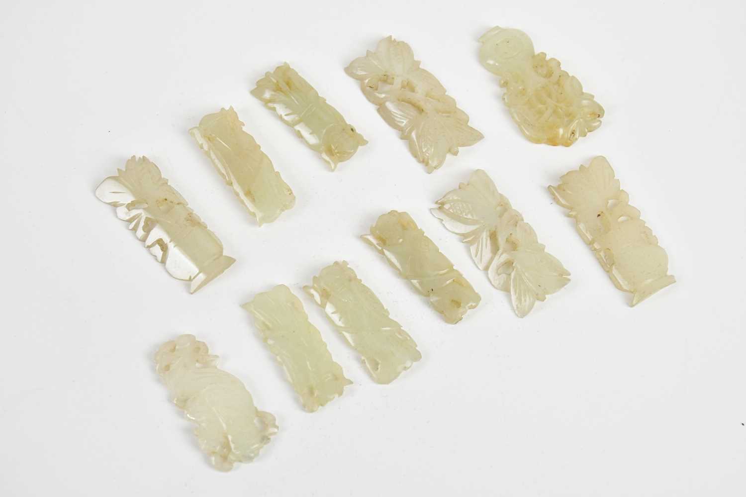 Lot 45 - Twelve small Chinese carved jade panels,