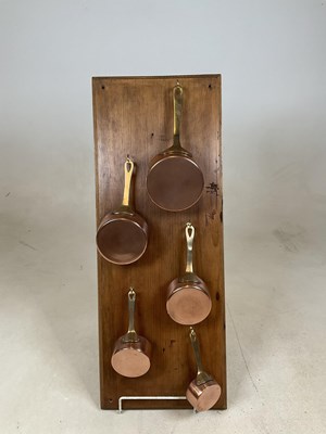 Lot 204 - Five small graduated copper and brass pans...