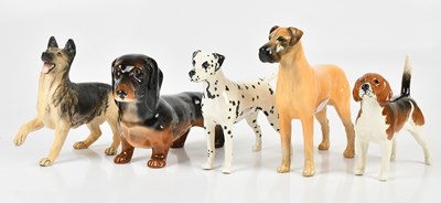 Lot 2489 - BESWICK; five models of dogs, including...