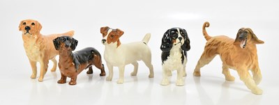 Lot 2490 - BESWICK; five models of dogs, including golden...