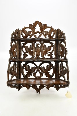 Lot 1149 - A 19th century carved lime wood hanging shelf,...