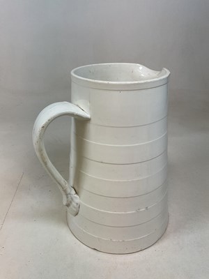 Lot 298 - A large late 19th century cream glazed milk...