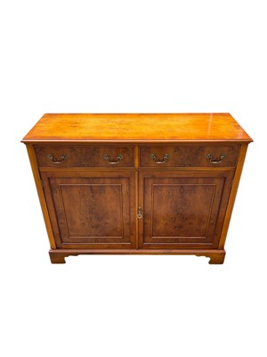 Lot 2230 - A reproduction yew wood two drawer sideboard,...