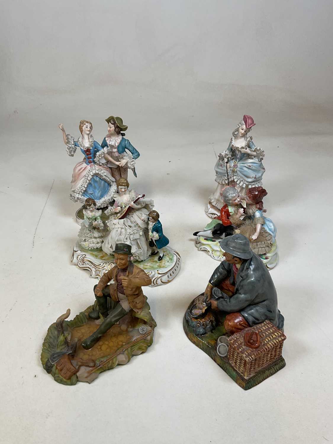 Lot 231 - A group of decorative porcelain figures...