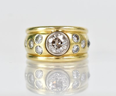 Lot 1300 - An 18ct yellow gold ring set with a central...