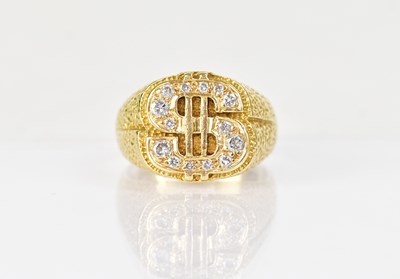 Lot 1299 - An 18ct yellow gold ring with dollar sign set...