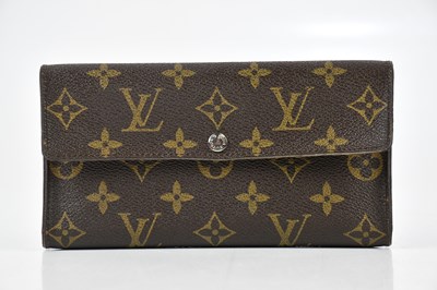 Lot 726 - LOUIS VUITTON; a brown and tan monogram wallet,...