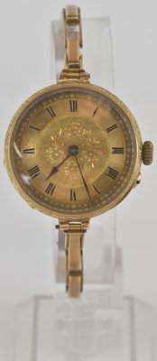 Lot 1474 - An 18k lady's wristwatch with allover floral...