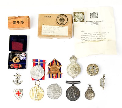 Lot 920 - A group of medals and badges including WWI War...