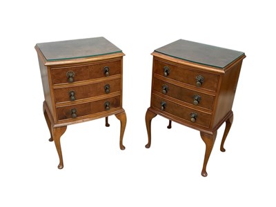Lot 2228 - A pair of reproduction three drawer walnut...