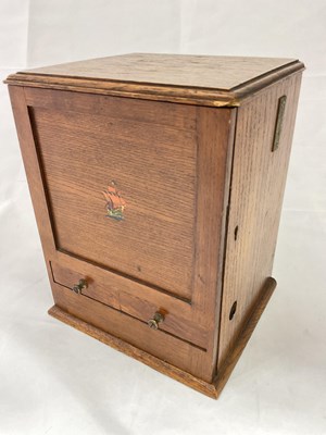 Lot 106 - An early 20th century oak cigarette dispenser,...