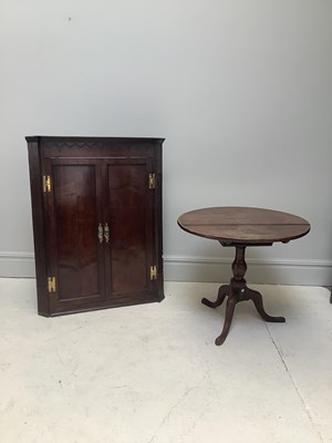 Lot 1080 - An 18th century oak hanging corner cupboard,...