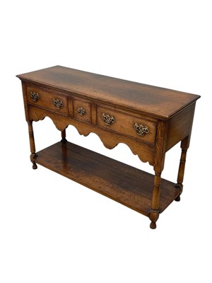 Lot 2213 - A small reproduction oak dresser base, with an...