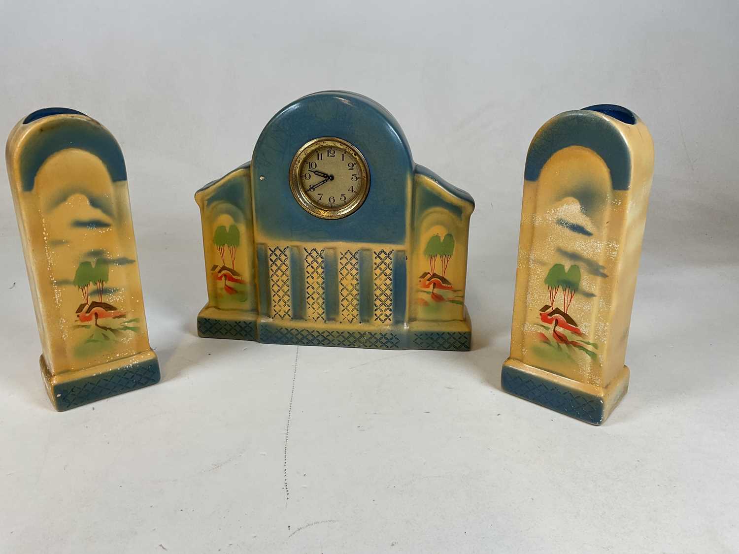 Lot 644 - An Art Deco pottery three piece clock...