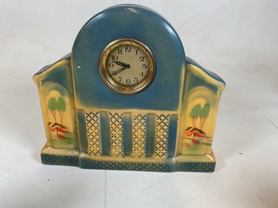 Lot 644 - An Art Deco pottery three piece clock...