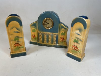 Lot 644 - An Art Deco pottery three piece clock...