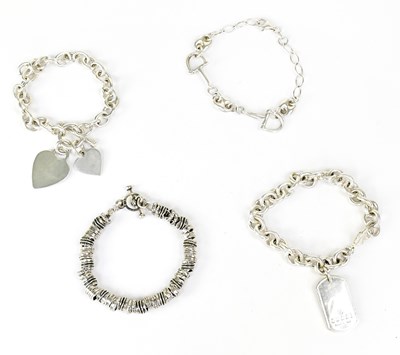 Lot 1426 - Four various silver chain bracelets,...