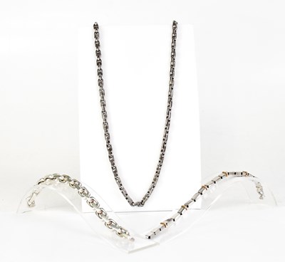 Lot 1501 - A silver chain link necklace with elongated...