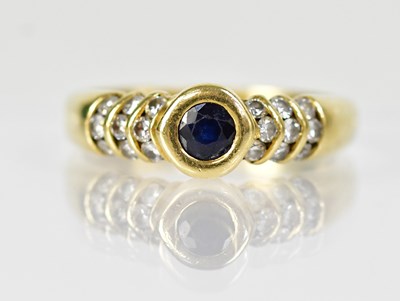 Lot 1272 - An 18ct yellow gold ring with a central round...