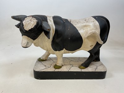 Lot 72 - A large painted model of a cow on wooden base...