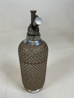 Lot 41 - A double gourd soda syphon with mesh cage and...