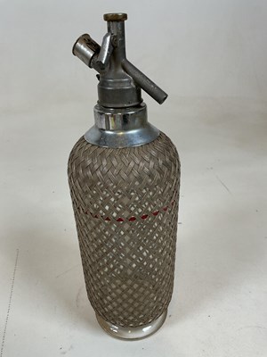 Lot 41 - A double gourd soda syphon with mesh cage and...
