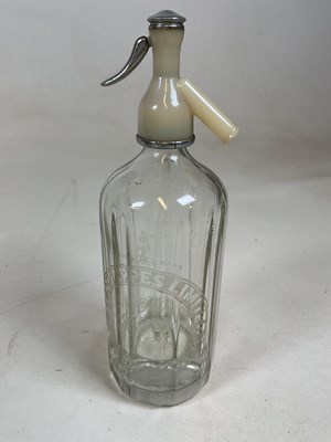 Lot 41 - A double gourd soda syphon with mesh cage and...