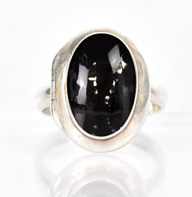 Lot 1360 - A silver poison ring set with an oval onyx...