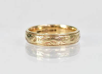 Lot 1323 - A 9ct yellow gold wedding band with foliate...