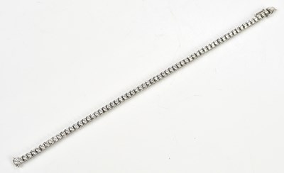 Lot 20 - A white metal diamond set tennis bracelet,...