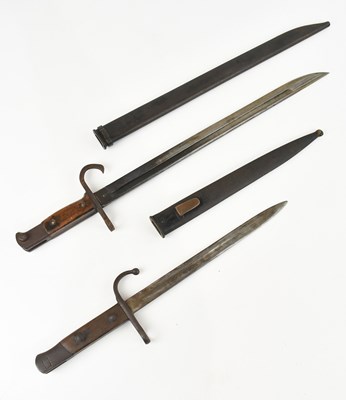 Lot 1340 - Two WWI period French bayonets, with scabbards,...
