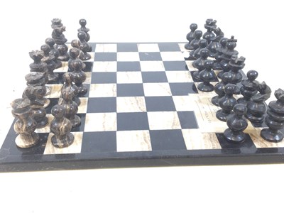 Lot 81 - A onyx chess set with board.