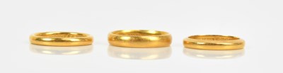 Lot 336 - Three 22ct gold wedding bands, sizes P, L and...