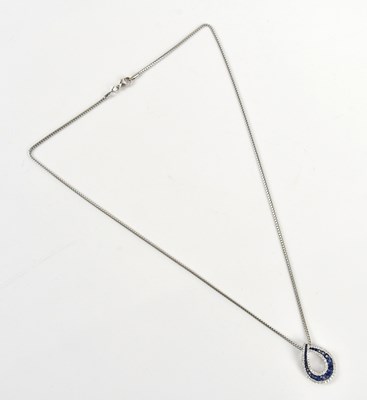 Lot 247 - A white metal diamond and sapphire pendant,...