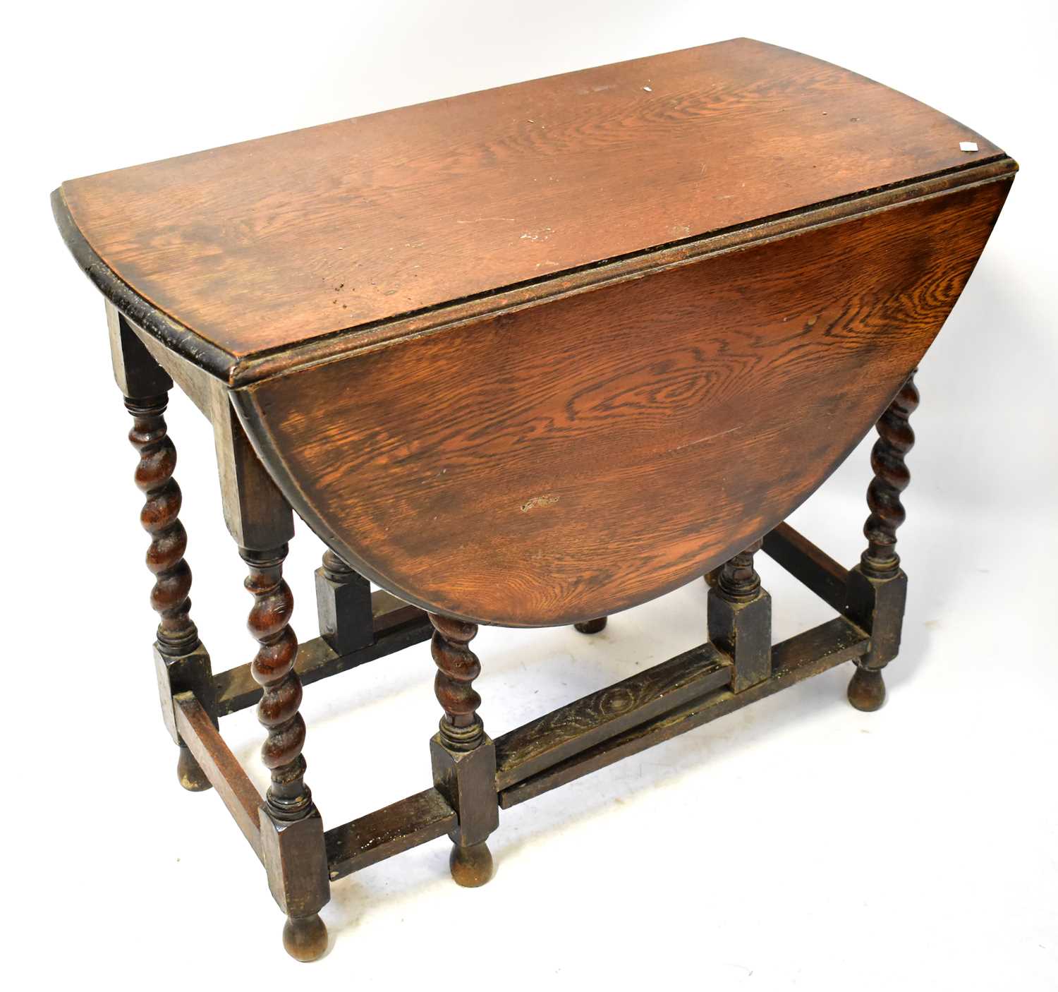 Lot 6 - A 1930s oak gateleg drop-leaf table, on barley...