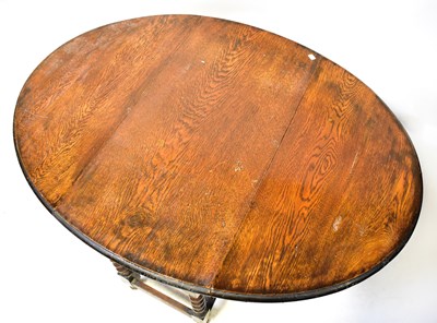 Lot 6 - A 1930s oak gateleg drop-leaf table, on barley...