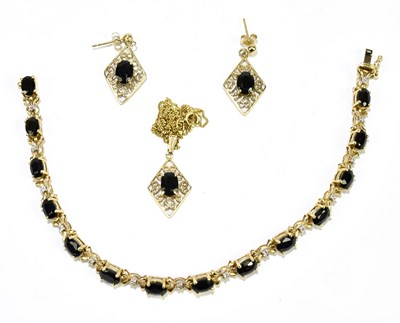 Lot 1264 - A 9ct yellow gold sapphire and diamond line...