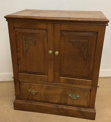 Lot 792 - ALBERT OAKROYD; a carved oak TV cabinet, width...