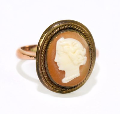 Lot 1233 - A 9ct yellow gold dress ring set with a carved...