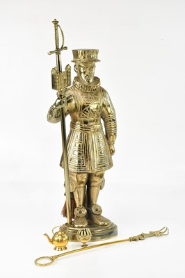 Lot 1558 - A large brass companion set modelled as a...