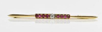 Lot 79 - A yellow metal diamond and ruby set bar brooch,...