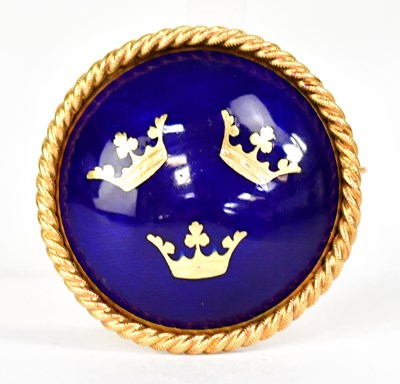 Lot 1390 - An 18ct yellow gold circular brooch with blue...