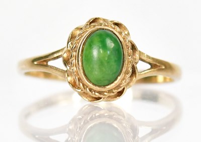 Lot 1340 - A 9ct yellow gold ring set with an oval green...