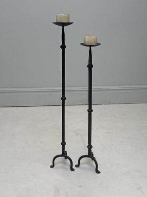 Lot 1294 - Two wrought iron pricket candlesticks, largest...