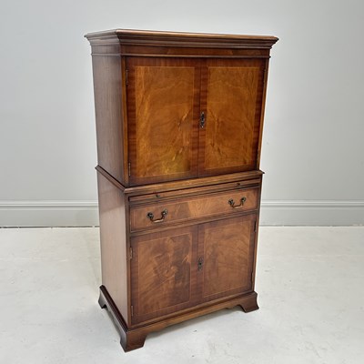 Lot 1123 - A reproduction mahogany two door drinks...